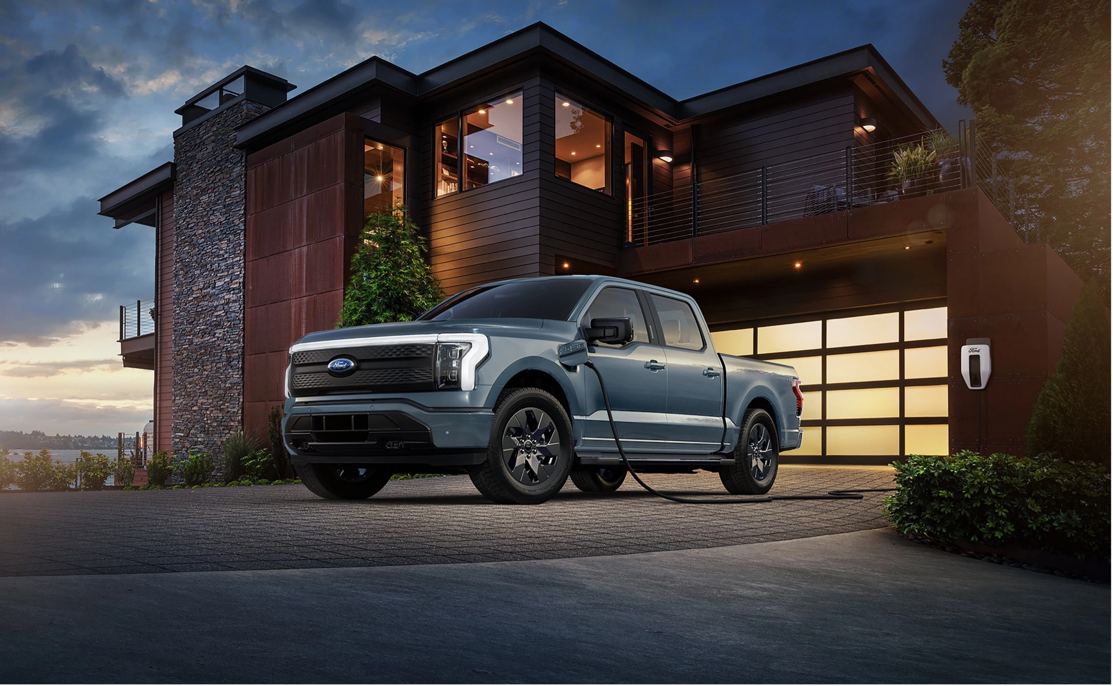 F150 Lightning plugged in and charging outside of a home.